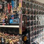 YouTuber Lochie Jones holding beer can and coin next to gravestone