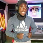 IShowSpeed standing next to older woman rubbing hands