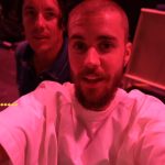 A mom embraces her son after he opens his first paycheck.