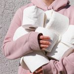 Two women use their smartphones while wearing kimono in Japan.