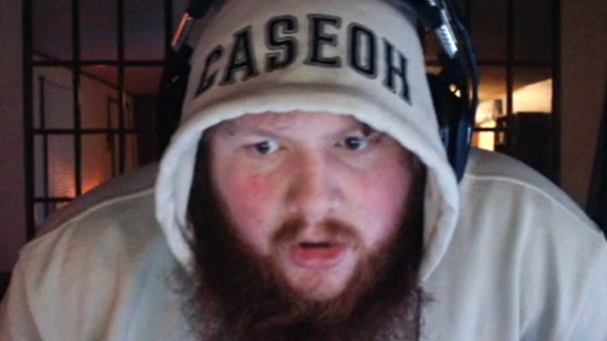 A mother holds her newborn daughter while competing in a fighting game tournament.