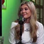 Asmongold holds his head in his hand with the OTK logo on the side.