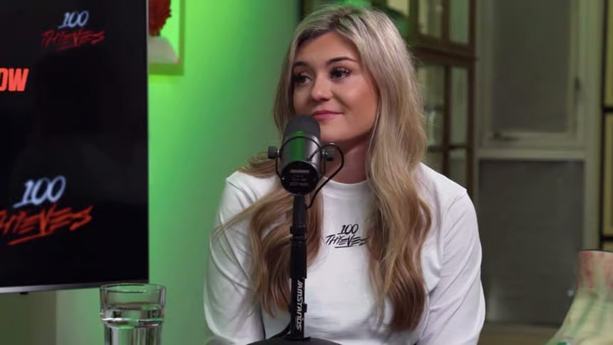 Asmongold holds his head in his hand with the OTK logo on the side.