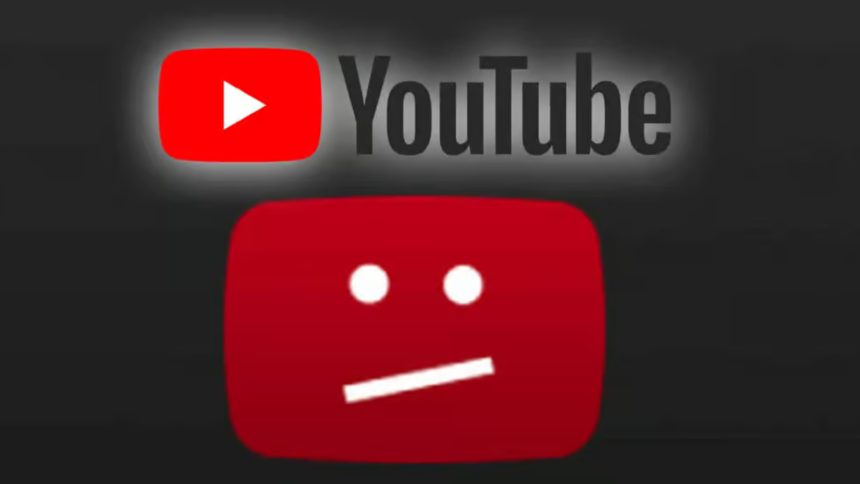 A photo of a man holding up the YouTube application on a smartphone.