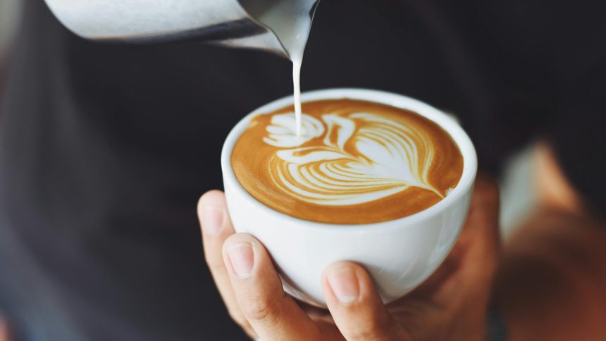 A cheeseburger on a background of gold bars and coins.