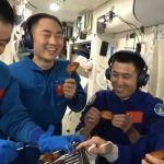 a man eating chicken from a kfc vending machine