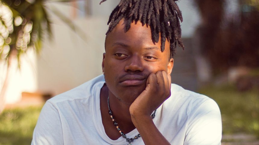 Rizzbot robot with arms out and cowboy hat on gesturing at camera