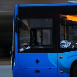 Man holding phone while in driving sat of Audi car
