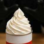 food being dipped into salsa pot with sauce