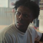 Blonde child shouting 67 at camera