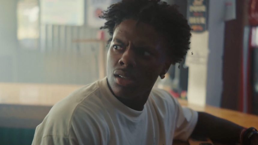 Blonde child shouting 67 at camera