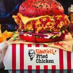 a man eating chicken from a kfc vending machine