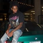 IShowSpeed staring at smashed window in red shirt and red cap