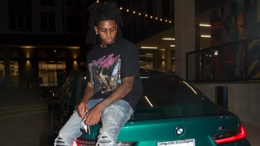 IShowSpeed staring at smashed window in red shirt and red cap