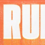 AI artist Xania Monet looking at camera while in pink seat