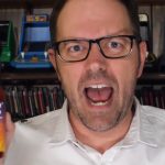 james rolfe holding new angry video game nerd 8-bit game