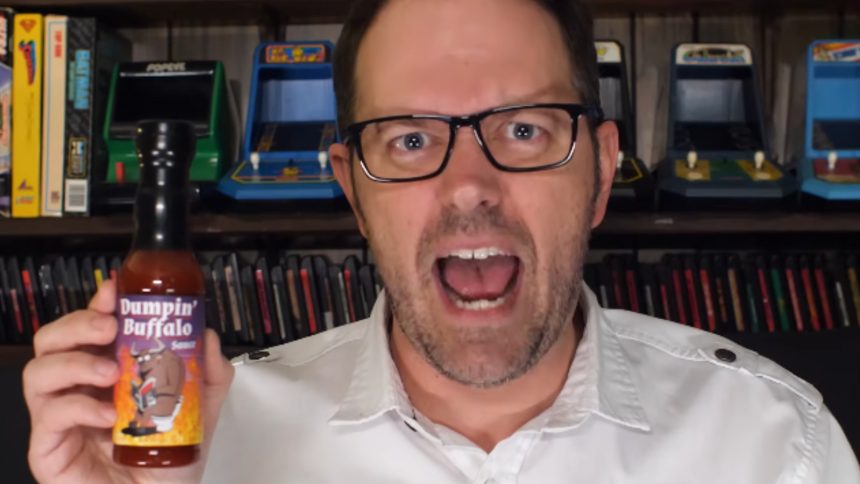 james rolfe holding new angry video game nerd 8-bit game