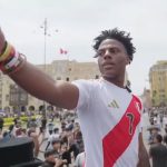 Ishowspeed pointing at crowd in Peru football shirt