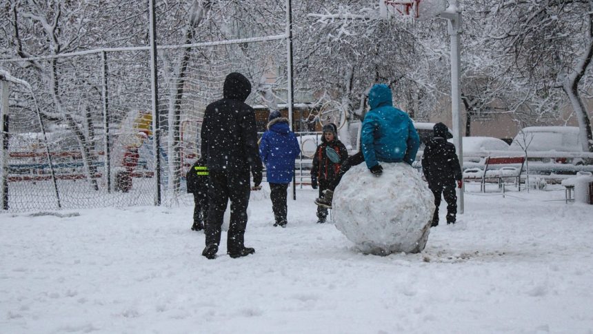 students play in snow at school