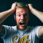 Blonde child shouting 67 at camera