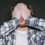 Man covering his eyes