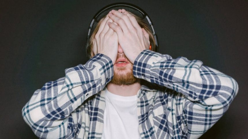 Man covering his eyes