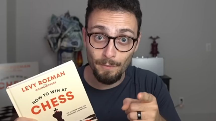 gothamchess holding his 'how to win at chess' book