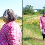 Woman in pink using drone and walking arounf farm