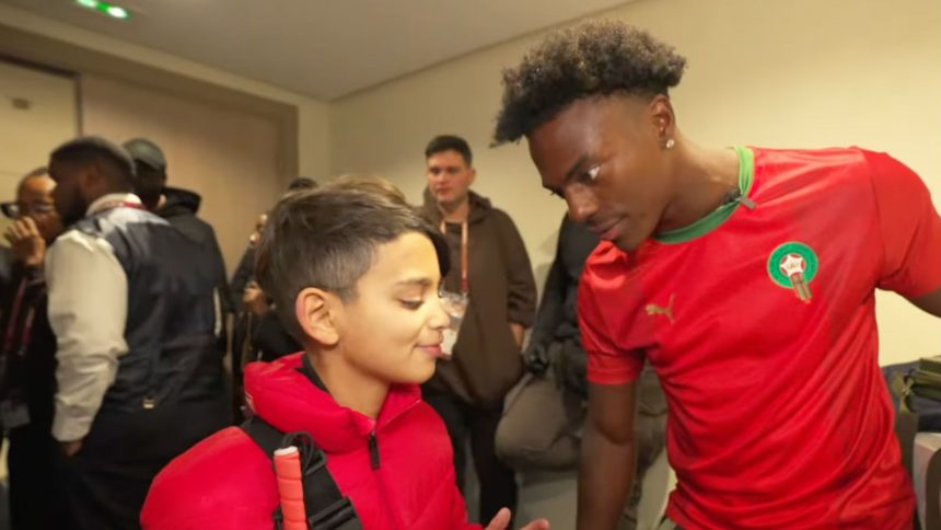 Ishowspeed and blind fan in red coat staring at each other