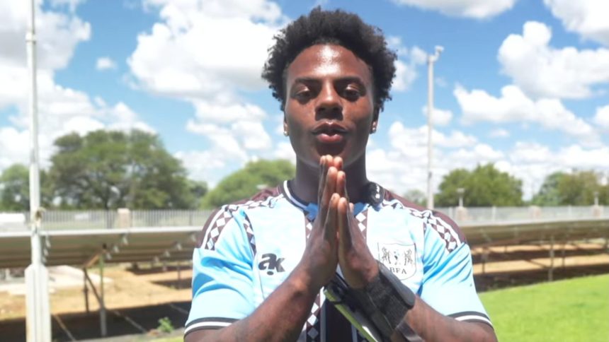 IShowSpeed in blue Botswana football shirt holding hands