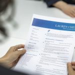 Job application being held by woman
