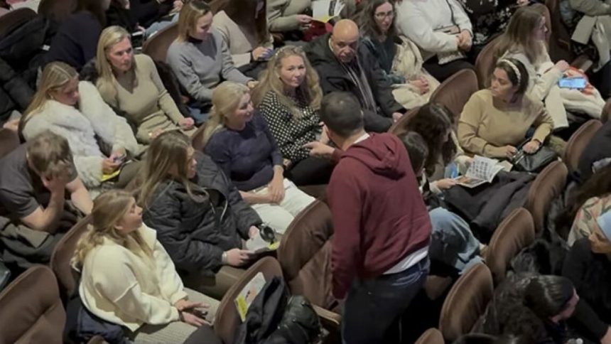 Man shouting in theater at showgoers