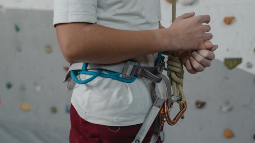 Climber next to a climbing wall
