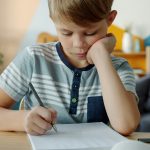 Kid at desk doing homework