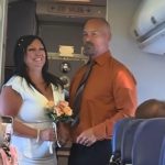 A picture of a couple being married on a flight