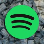 Spotify logo in front of pile of money