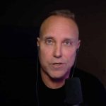 Swifty sat in black t-shirt talking to camera