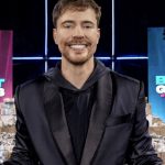 MrBeast standing in front of piles of money in the Beast Games Season 2 poster