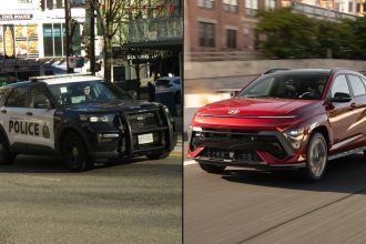 Police car alongside red SUV on road