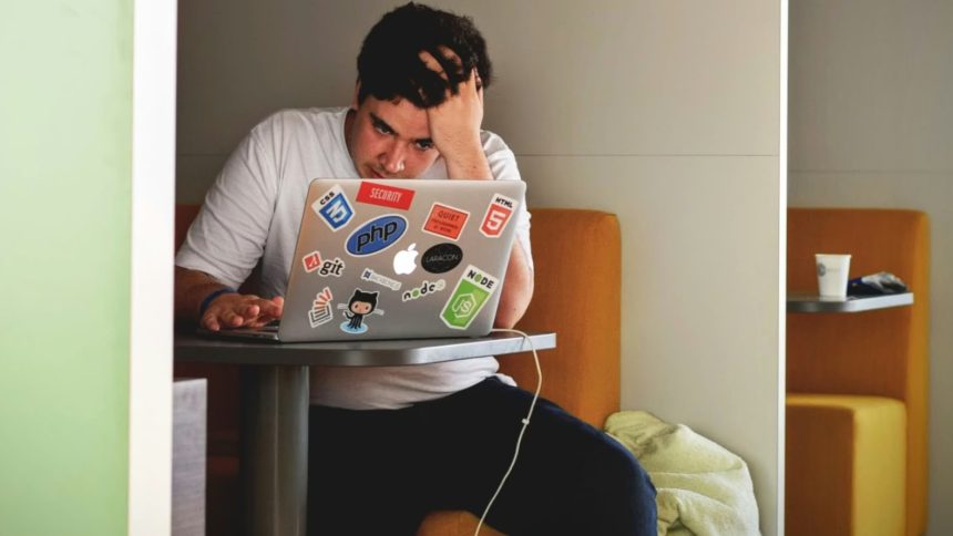 Student struggling in front of laptop