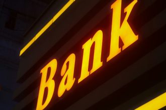 Bank text lit up in orange outside building