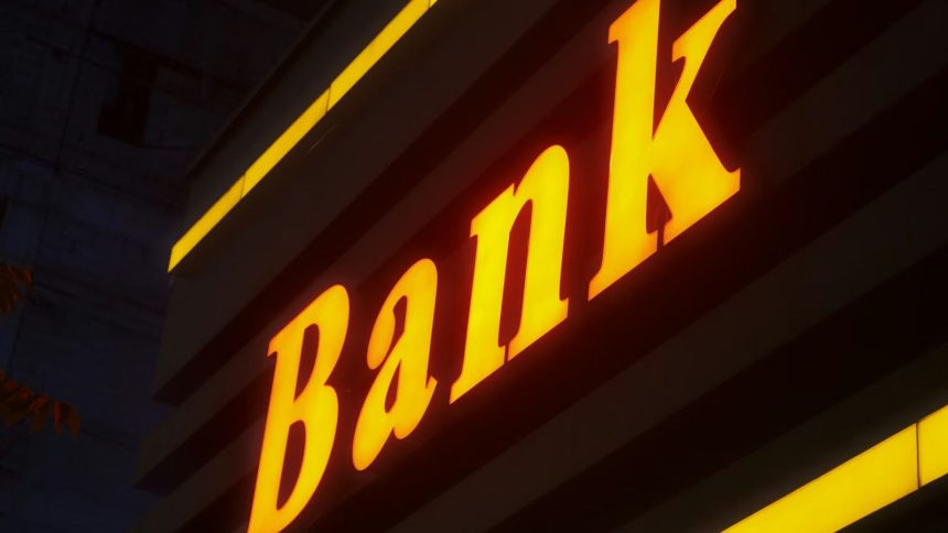 Bank text lit up in orange outside building