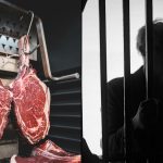 Meat hanging up in freezer next to silohuette of man in jail