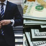 Lawyer fastening suit and walking down stairs alongside stack of money