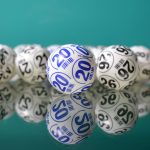 White lottery ball spread out on glass table