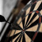 Dart in the middle of bullseye on darts board