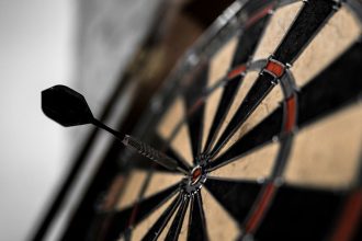 Dart in the middle of bullseye on darts board